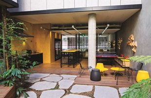 The ‘L’-shaped building encloses the internal courtyard on the ground floor where students can eat and socialise in a retreat away from the traffic and noise